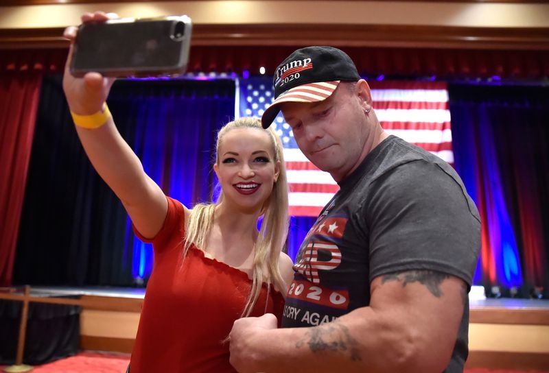 Mindy Robinson (L) takes a selfie with John Wayne Bobbitt at the Nevada Republican Party's election results watch party at the South Point Hotel & Casino on November 6, 2018 in Las Vegas, Nevada. (David Becker / Getty Images)