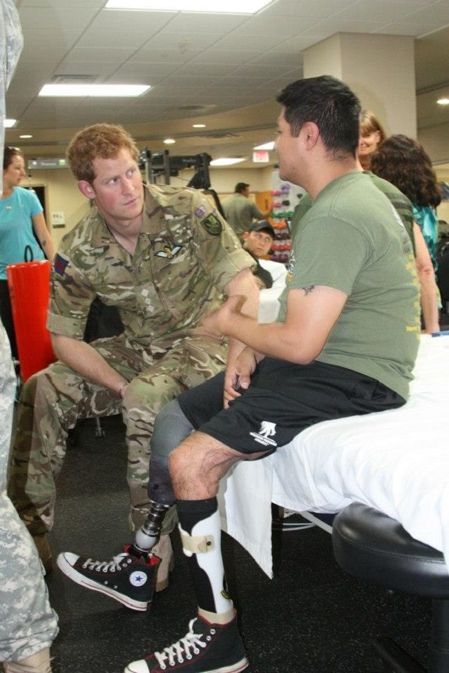 Prince Harry talking with an injured army while he was serving as an army (Source: commons.wikimedia.org)
