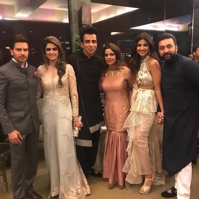 Caption: Sonali Sood posing for a photo with prominent Bollywood actors alongside her husband, Sonu Sood. Source: Xoom